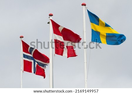 Three scandidavian flags in the wind against the sky, Norway, denmark, sweden