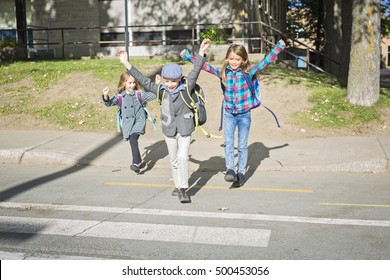 Three School Children Crossing The Street