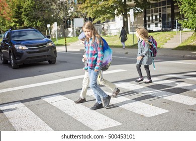 Three School Children Crossing The Street