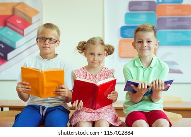 Three Schoolchildren Reading Books Classroom School Stock Photo ...