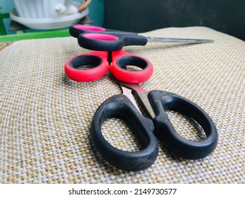 Three scissors of different sizes and colors