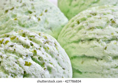 three scoops of green ice cream, pistachio, woodruff, peppermint or kiwi flavor, macro, close up, horizontal, full frame / Pistachio Ice cream