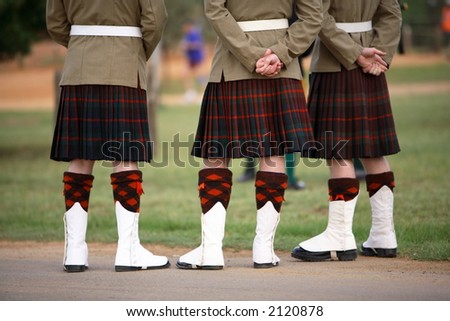 Three Scottish solders dressed in kilts