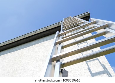 Three Section Aluminum Ladder Leaning Against House