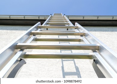 Three Section Aluminum Ladder Leaning Against House