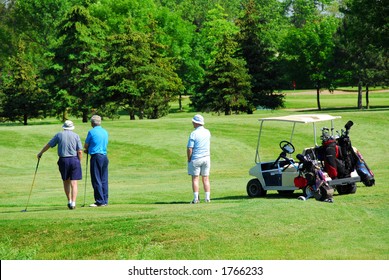 Three Senior Men On Golf Course With A Golf Cart