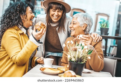 Three senior women enjoying breakfast drinking coffee at bar cafeteria - Life style concept with mature female having fun hanging out on city street  - Powered by Shutterstock