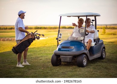 Three Seniors Golfers. Man And Woman In Golf Car. 