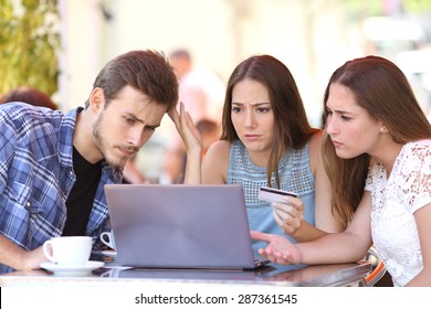 Three Shopper Friends Buying Online With Credit Card Finance Problems In A Coffee Shop