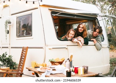 Three Siblings Children Boys And Girl Looking Out Of Window Of Cozy Kitchen In Trailer Mobile Home Or Recreational Vehicle During Autumn Family Local Travel Having Fun Together And Having Breakfast