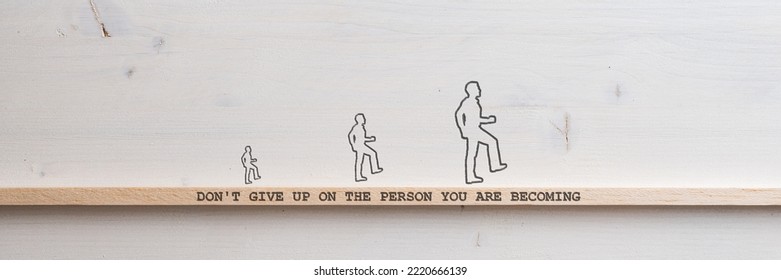 Three Silhouettes Of A Man Each Bigger Than The Other Walking Across A Wooden Slat With A Dont Give Up On A Person You Are Becoming Sign On It In A Conceptual Image Of Personal Development And Growth.