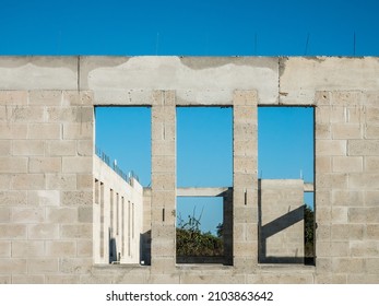 Three Similar Window Openings In Exterior Concrete Wall Of A Single-family House Under Construction In A Suburban Development On A Sunny Morning In Southwest Florida