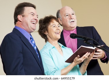 Three Singers Performing From The Church Hymnal.