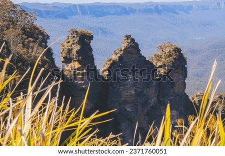 The Three Sister Rocks, Blue Montains National Park in New South Wales, Australia. Sunny Rocks Covered by Trees.

