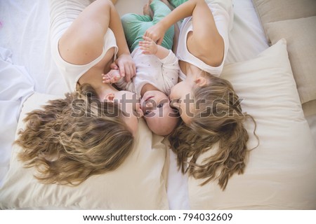 three sisters play children in the morning in the bedroom