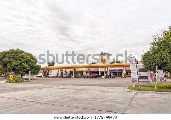 THREE SISTERS, SOUTH AFRICA - APRIL 2, 2021: A\
gas station at Three Sisters in the Northern Cape Karoo. Vehicles\
and people are visible