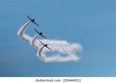 Three of the Skytypers acrobatic airplane performance team perfoming at the Jones Beach Air Show leaving a long smoke trail. - Powered by Shutterstock