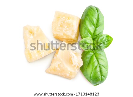 Three slices of permesan reggiano and basil bush isolated on white background, macro shooting, top view