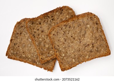 Three Slices Of Wholegrain Bread With Seeds Of Sunflower, Flax, And Sesame. Healthy Vegetarian Food. Isolated Flatlay.