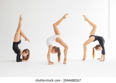 three slim artistic teenager girls in black and white leotards trains and having fun on white background in rhythmic gymnastic exercise, children's professional sports