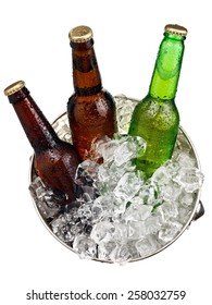Three small beer bottles in a bucket with ice, top view