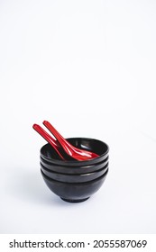 Three Small Black Bowl With Red Soup Spoon On White Background