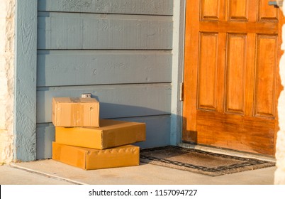 Three Small Boxes Left On The Front Door. First Thing In The Morning Sunrise On Early Package Delivery. Early Bird Gets The Worm. 