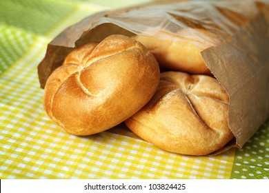 Three Small Buns Made Of White Flour In Paper Bag