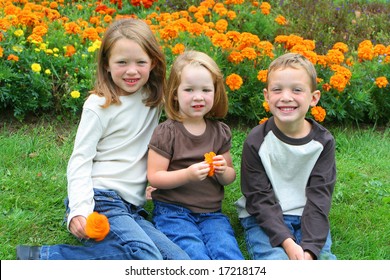 Three Small Children One Boy, Two Girls, Brothers And Sisters