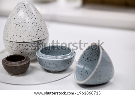 Three small stone egg-shaped boxes with opening top.