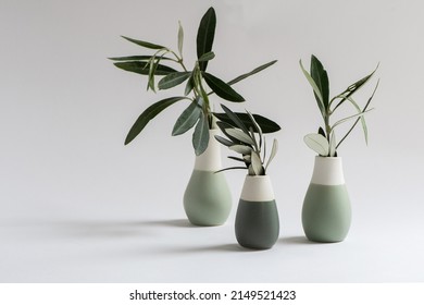 Three small vases with olive branches in front off white background. Modern minimalist style. Interior object decorations.  - Shutterstock ID 2149521423