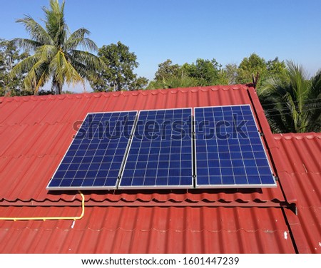 Three Solarcell Panels on Red Roof Top