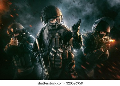 Three soldiers in full uniform with guns is going to attack. Uniform conforms to special services FSB (soldiers) of the Russian Federation. Shot in studio. Explosion on a black background