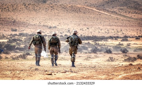 Three Soldiers Walking In The Desert