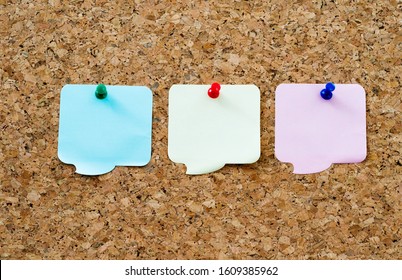 Three Speech Bubbles Pinned On Cork Board.