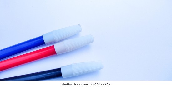 Three spidol black, red and blue isolated on white background - Shutterstock ID 2366599769