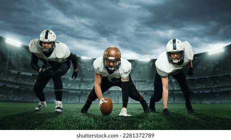 Three sportsmen, american football players in uniform getting ready to play at open air at 3D stadium in evening time. Championship. Concept of sport, competition, action and motion, game, cup. - Powered by Shutterstock