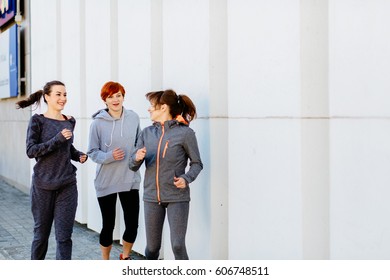 Three sporty young women running in the city Sport lifestyle.