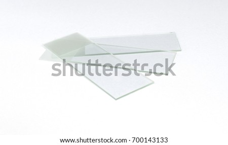 Three spread Glass Microscope Slides, white background isolated
