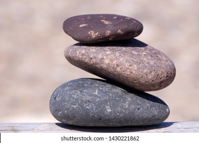 Three Stacked Stones With Beach Background