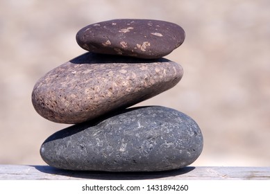 Three Stacked Stones In The Sunlight