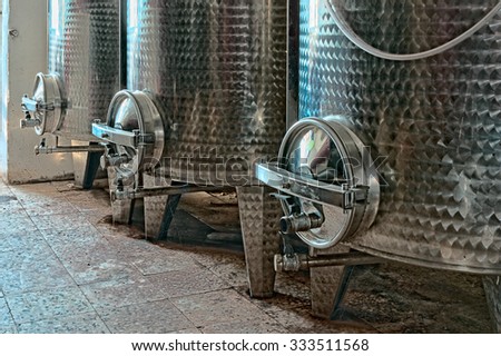 Three steel vats for wine 