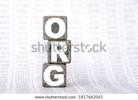 three stone cubes on the background of white financial statements, tables with the word org. Strong business concept