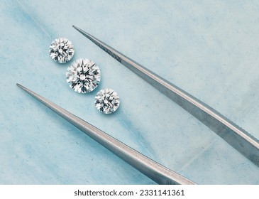 Three Stone Set of Diamonds - Trilogy Lab-Grown Diamond Set with Tweezers in Open Blue Parcel - Shutterstock ID 2331141361