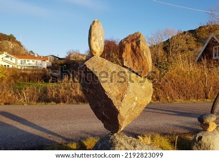 Three stones balanced by gravity