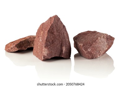 Three stones, fragments of crimson quartzite on a white background