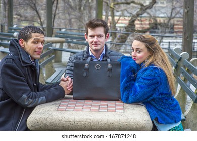 Three students are sitting by a table in a chilling winter, charmingly looking at you. / Three friends waiting for you 