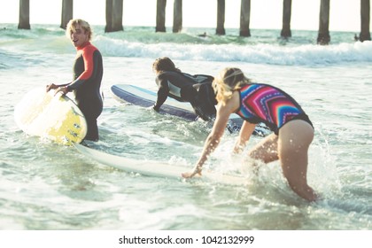 Three surfers practicing in the ocean