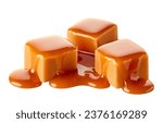 Three sweet caramel candy cubes topped with caramel sauce isolated on white background