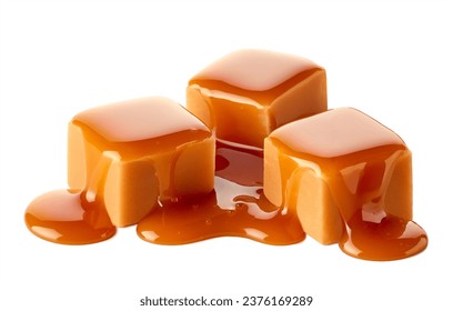 Three sweet caramel candy cubes topped with caramel sauce isolated on white background